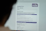 Woman looks at the NDIS complaints form online 