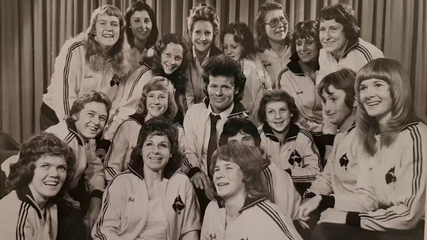 A black and white photo of a women's soccer team wearing an Australian uniform