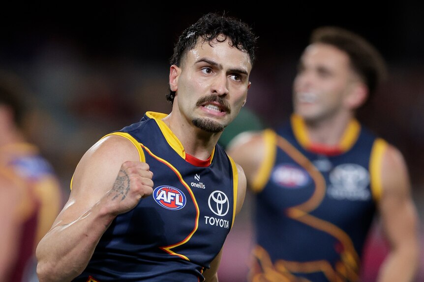 Adelaide Crows' Izak Rankine pumps his fist after a goal against the Brisbane Lions in an AFL game.