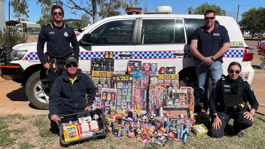 police pose next to fireworks