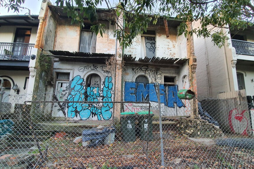 Derelict terrace houses covered in graffiti.