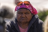 Anne Jones in a jacket and head scarf