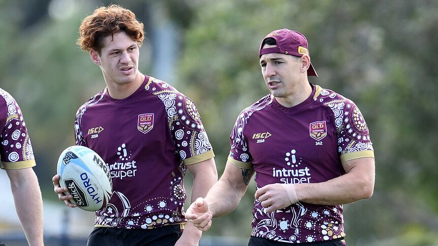 Kalyn Ponga looks on, as Billy Slater speaks at a Queensland State of Origin training session.