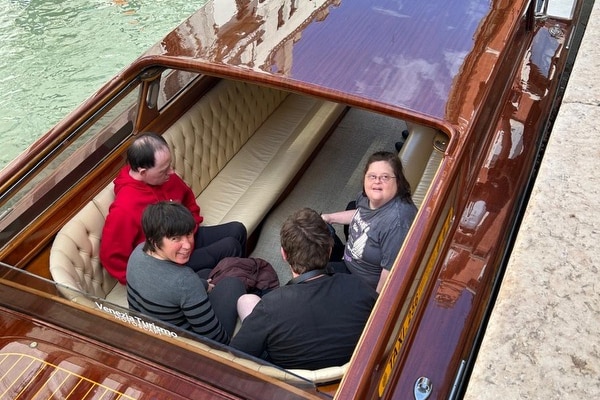 Four people in a boat in Venice.