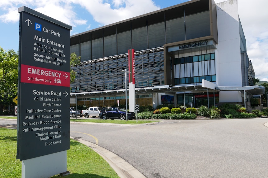 An outdoor sign pointing to a hospital's emergency department 