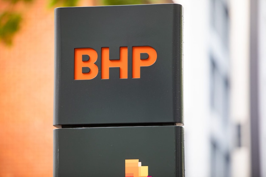 An orange BHP logo on a grey background.