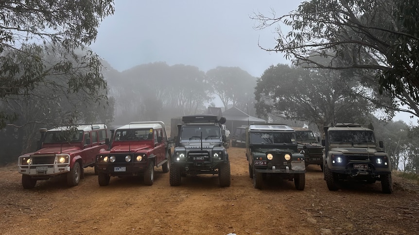Land Rovers on a misty mountain