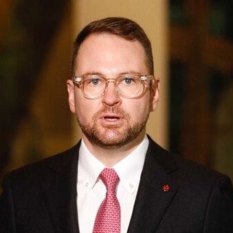 A man wearing a suit and glasses