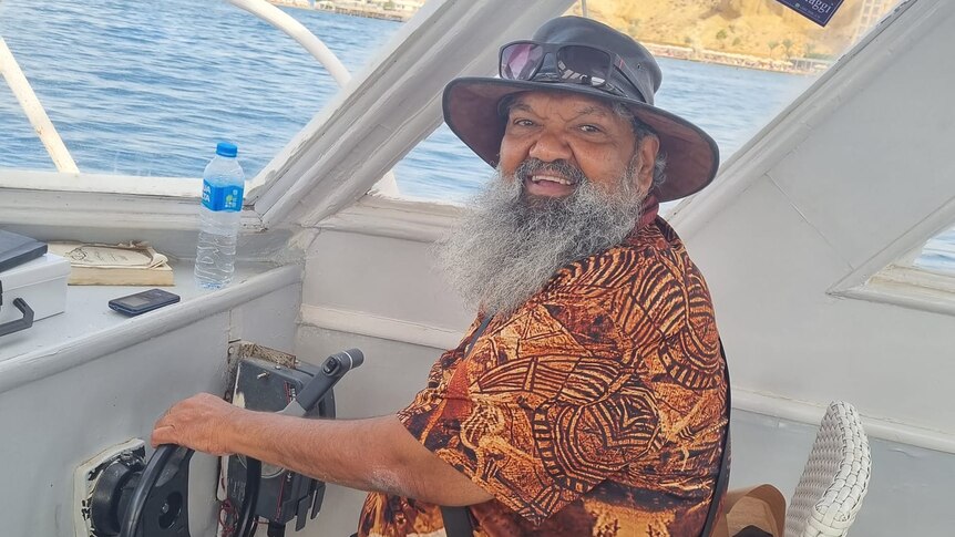 a man pretends to steer a boat