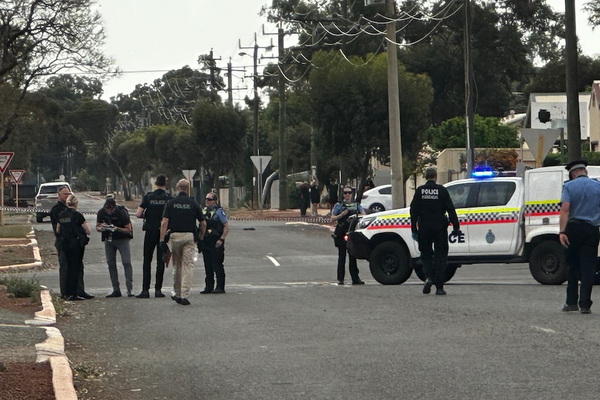 Police stand along a road 