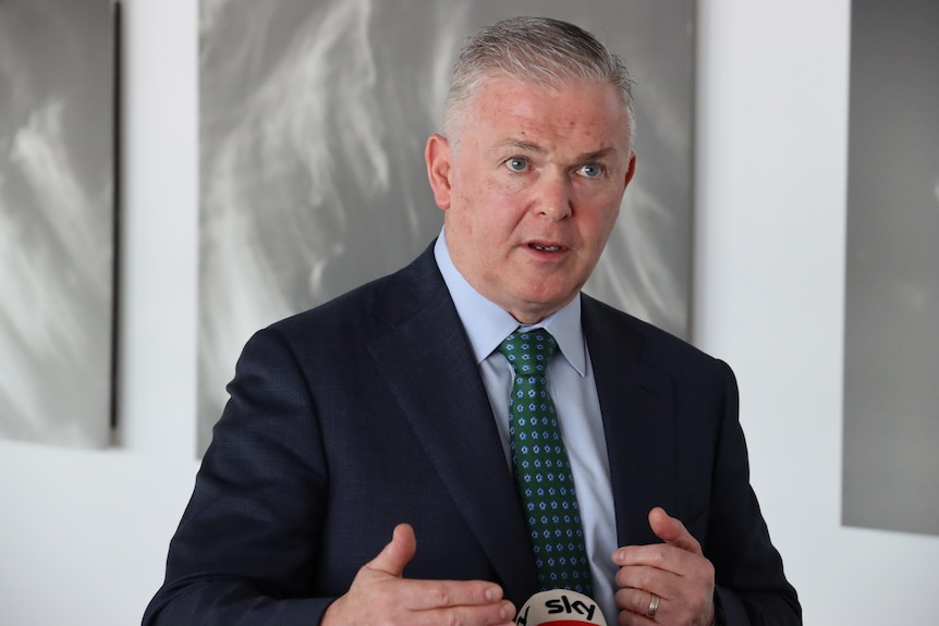 Kevin Gallagher wears a suit at a press conference in Darwin. 