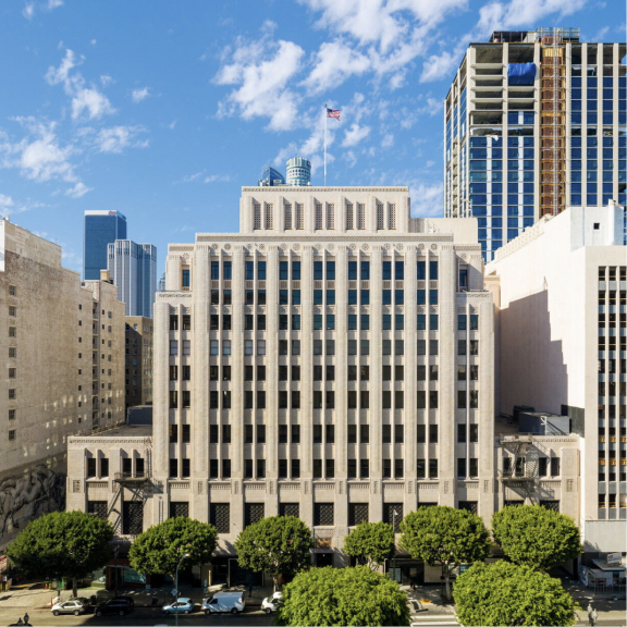 Top of UCLA's Trust Building in downtown Los Angeles surrounded by other buildings with text "Creating the future UCLA strategic plan  Deepen our engagement with Los Angeles"