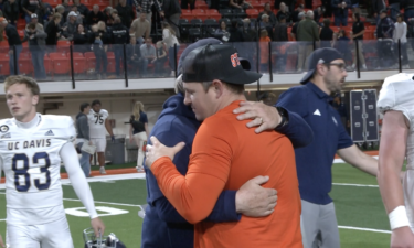 Cody Hawkins and Dan Hawkins embrace after game