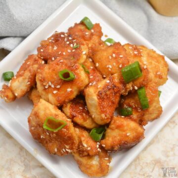 orange chicken on square rimmed white plate