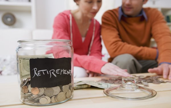 A couple counts out the coins from their retirement jar.