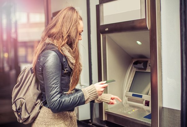 Person uses an ATM.