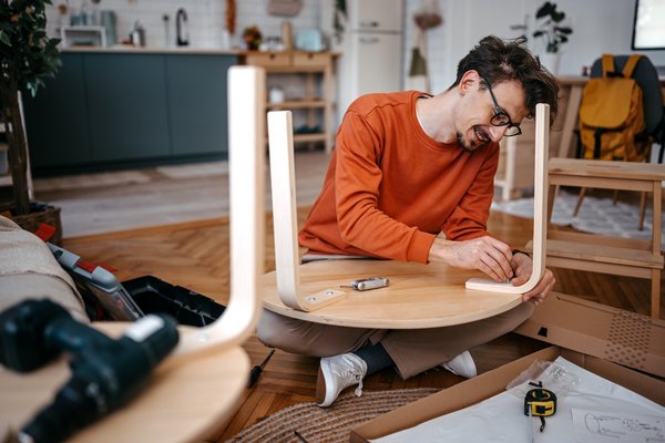 A person building furniture.