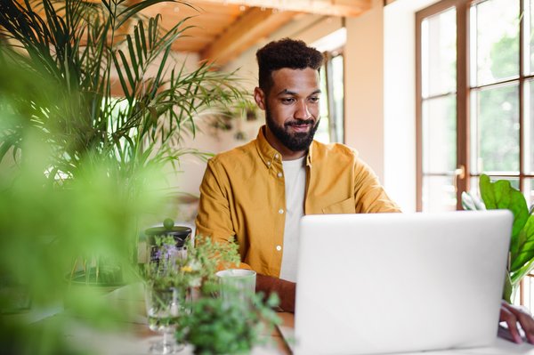 A person with a laptop and coffee.