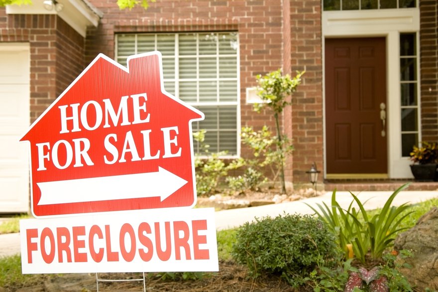 Foreclosure sign in front of house.