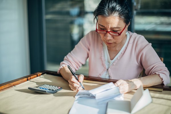 A person is studying and calculating at a desk.