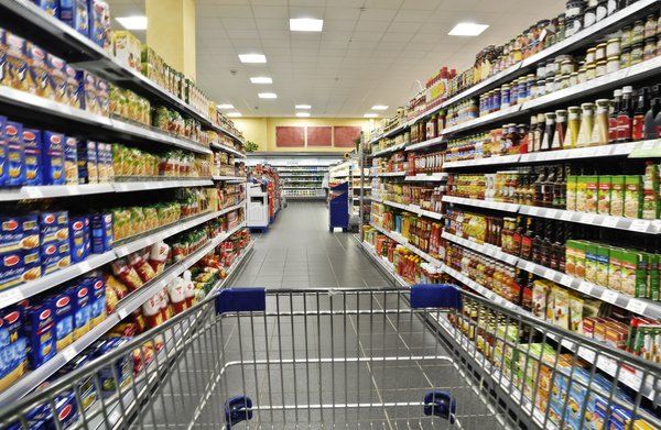 Shopping cart in a grocery aisle.