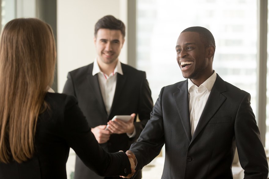 Smiling businesspeople sealing the deal with a handshake