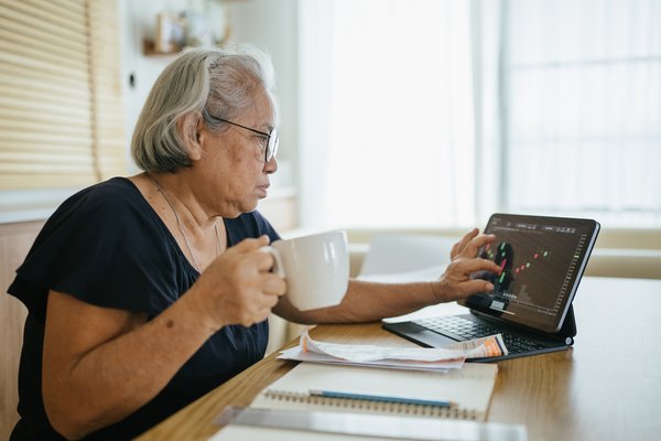 Person calculating expenses and bills at home.