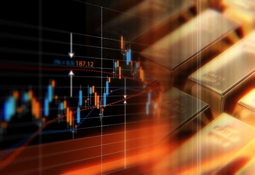 Gold bars next to an investment chart.