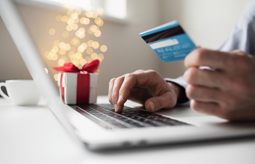 A person shops on their laptop for holiday gifts.