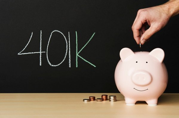 A person putting coins into a piggy bank.