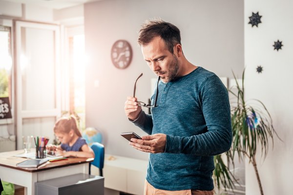 A man uses his cell phone intently.