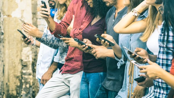 A group of people on their phones.