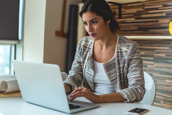 Person typing at a laptop.