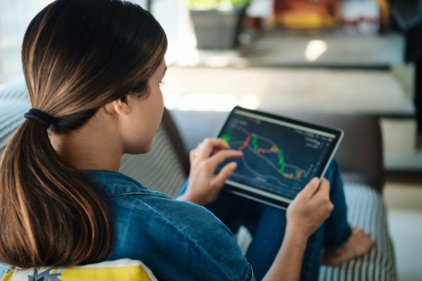 Person using tablet to look at the performance of stocks.