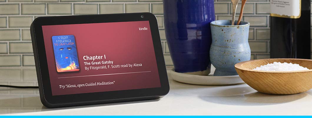 On a kitchen counter, an Echo Show displays Chapter One of the audiobook version of The Great Gatsby.