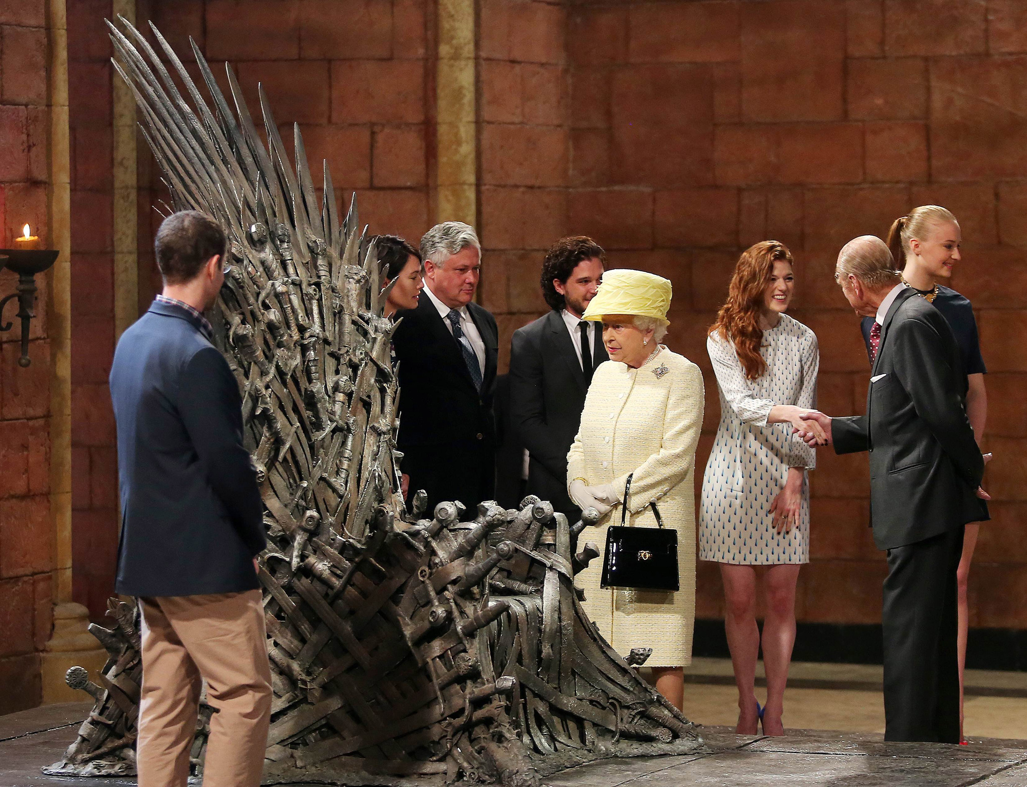  Queen Elizabeth II meets cast members of the HBO TV series 'Game of Thrones' Lena Headey and Conleth Hill while Prince Philip, Duke of Edinburgh shakes hands with Rose Leslie as they views some of the props including the Iron Throne on set in Belfast's Titanic Quarter on June 24, 2014 in Belfast, Northern Ireland.