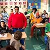 Doris (Kyla Pratt, seated left) brings her new friends, Fat Albert (Kenan Thompson) and the Cosby Kids to class with her.  Fat Albert's pals are (back row, L-R) Bill (Keith D. Robinson), Bucky (Alphonso McAuley) and Old Weird Harold (Aaron A. Frazier).  In the middle row are schoolmates played by Aaron Carter (L) and Joel Madden (R) seated beside Mushmouth (Jermaine Williams, center).  Dumb Donald (Marques B. Houston) is seated in the front row on the right.