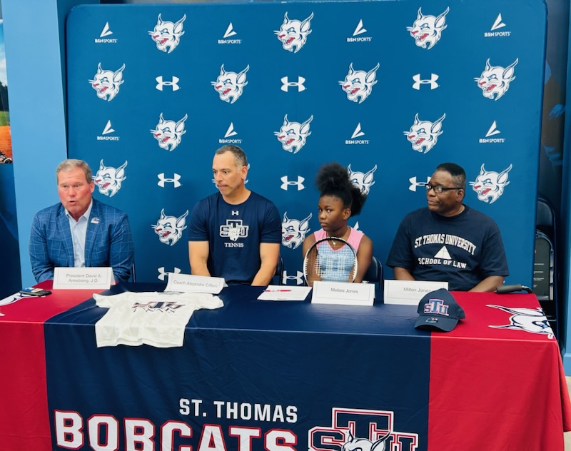 Tennis player Meloni Jones 8 years old signs. Coach Ciffoni, President David Armstrong and Milton Jones.