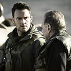 Tom Wilkinson and Owain Yeoman in SAS: Red Notice (2021)