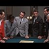 Frank Sinatra, Norman Fell, Dean Martin, Richard Conte, Sammy Davis Jr., Richard Benedict, Joey Bishop, Clem Harvey, Peter Lawford, Buddy Lester, and Henry Silva in Ocean's Eleven (1960)