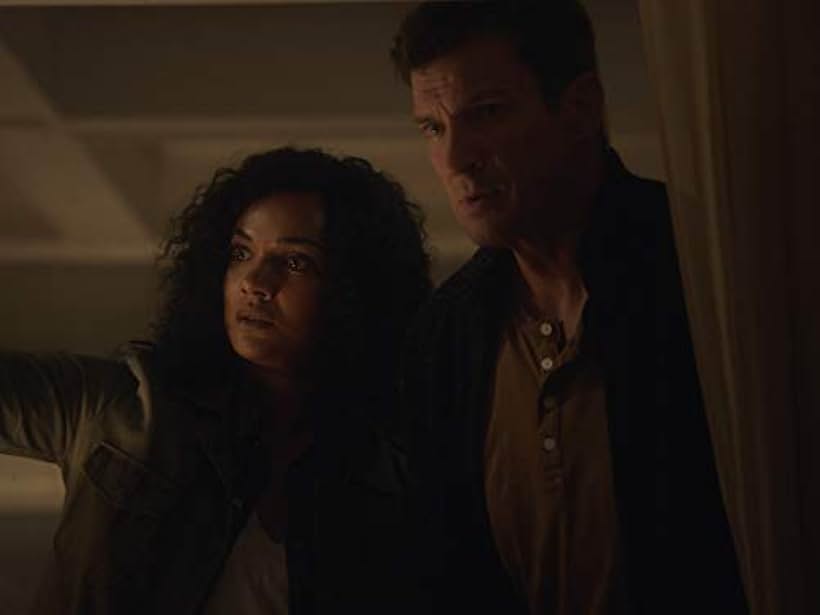 Nathan Fillion and Mekia Cox in The Overnight (2020)