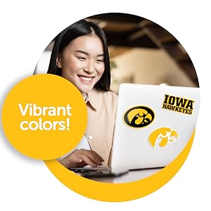 Woman using laptop with University of Iowa stickers on it, Hawkeyes, Herky the Hawk