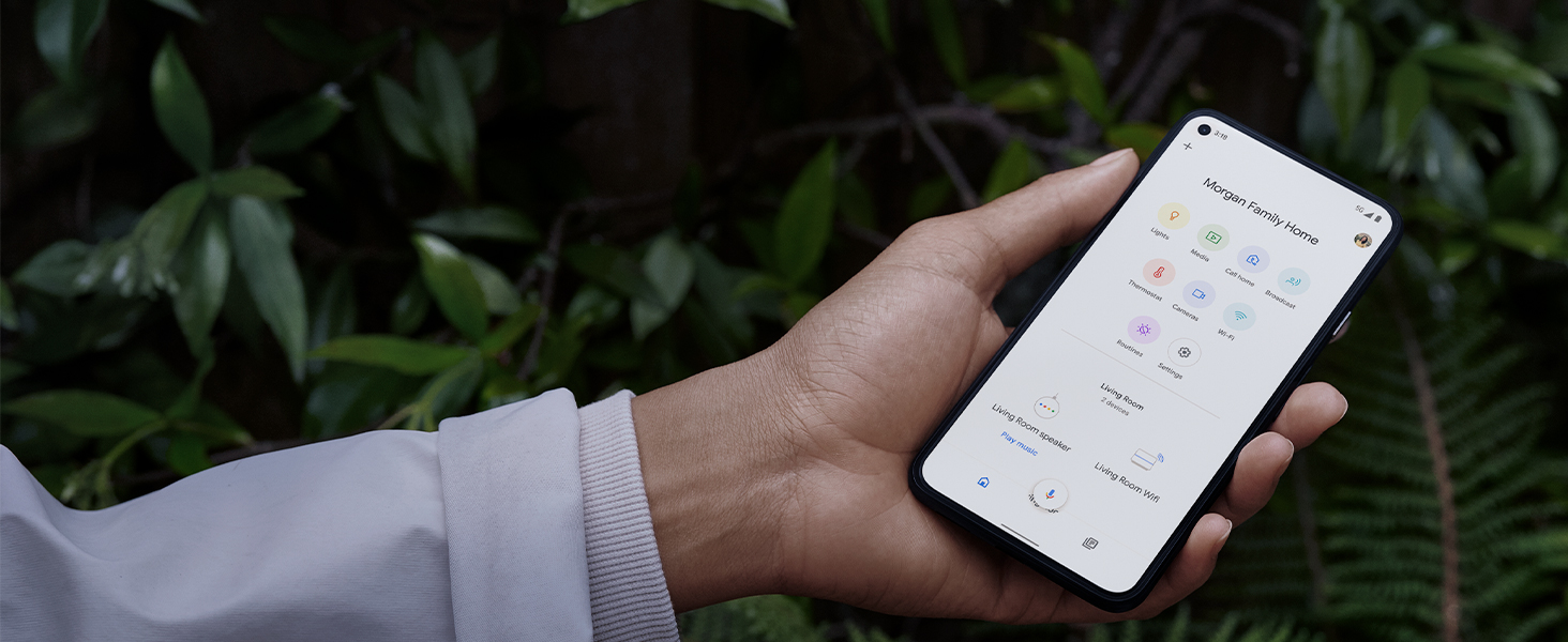 Person holding phone with Google Home App on screen