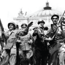 Various soldiers celebrate in the streets as Paris is liberated.