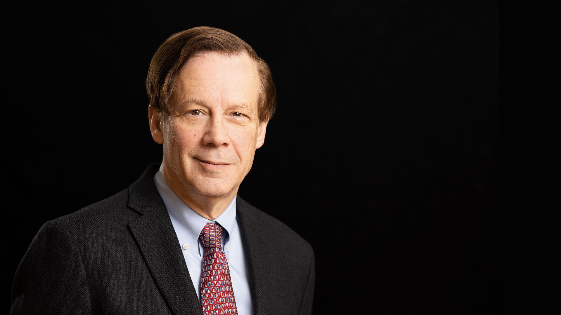 Portrait of man wearing suit and tie.