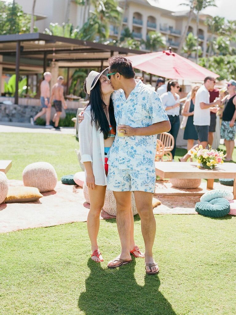 Couple Poses: Couple kiss at an outdoor party. 