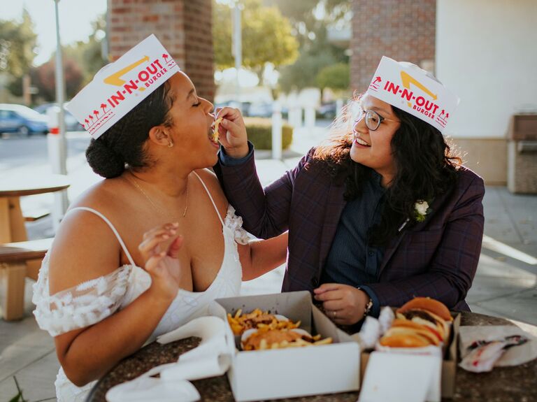 Cute Couple Poses: Couple feeds each other french fries outside an In-N-Out. 