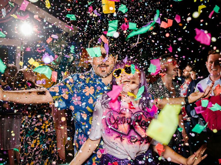 Cute Couple Poses: Couple dances while confetti falls around them. 