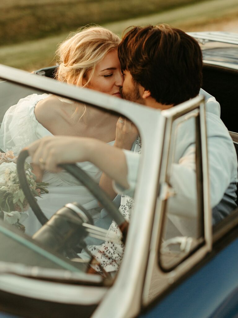 Couple Poses: Couple shares a sweet kiss in a retro car. 