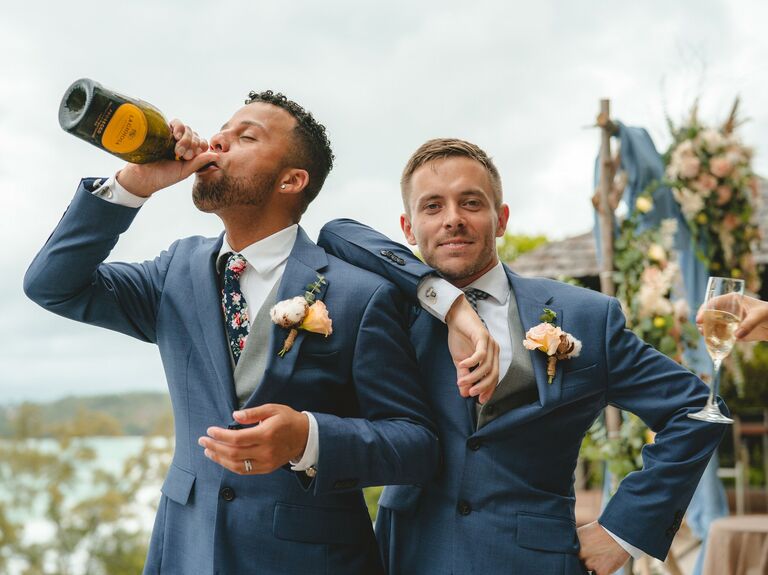 Couple Poses: Couple drink champagne while posing for camera. 